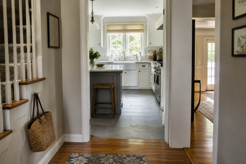 Late-summer view from a Manhasset-area home entryway toward a kitchen, illustrating deep-cleaning priority zones