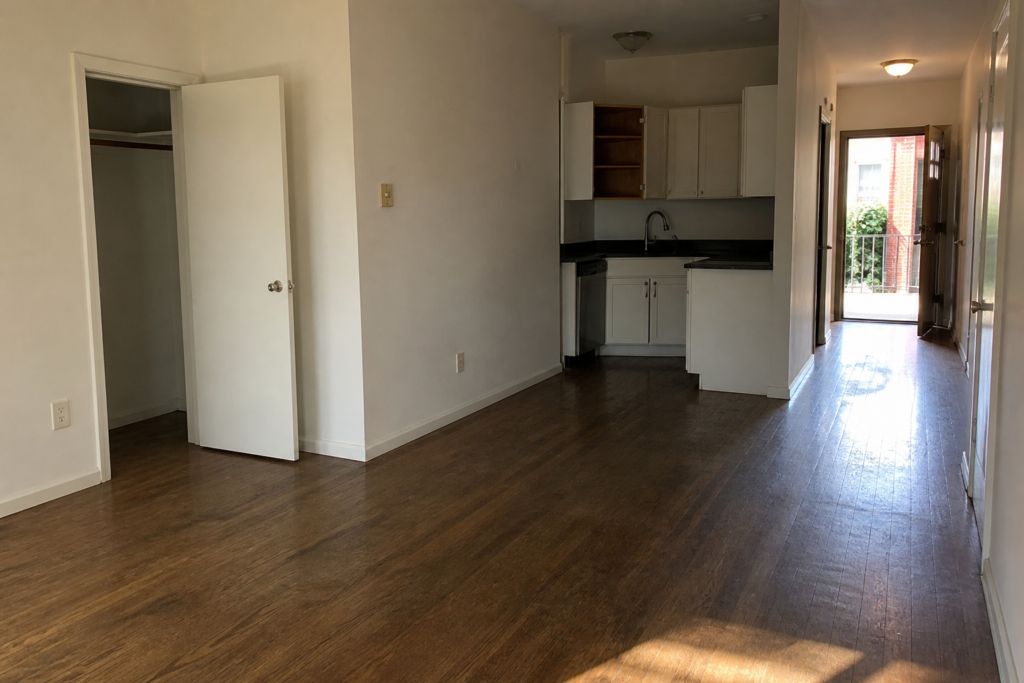 An empty Red Hook apartment with open cabinets and a clear path for a final move-out walkthrough